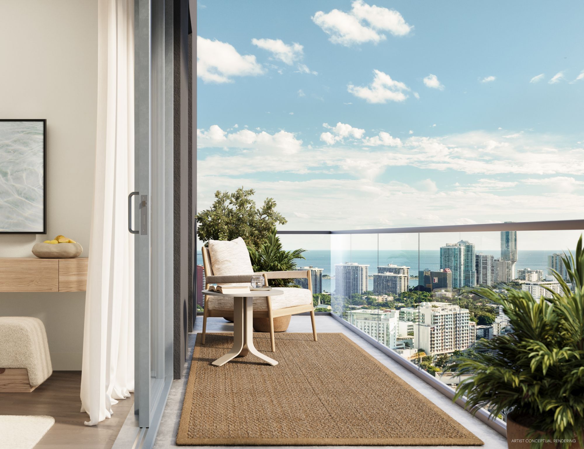 Balcón de una residencia de House of Wellness Brickell con sillón, mesa y vista abierta a la bahía de Biscayne y al skyline de Miami