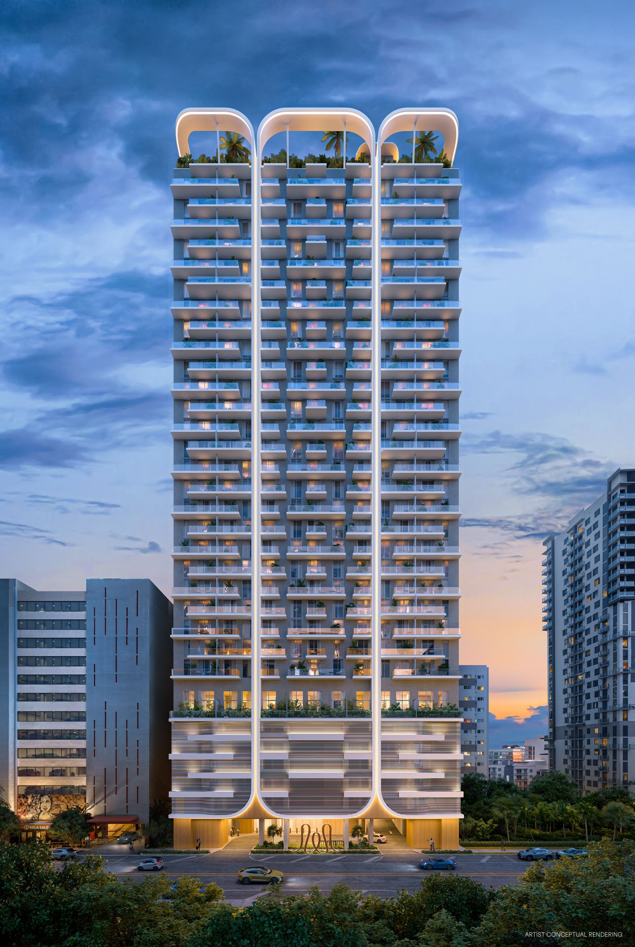 La torre House of Wellness iluminada de noche sobre 152 SW 9th Street, con sus balcones ajardinados y los arcos de la azotea