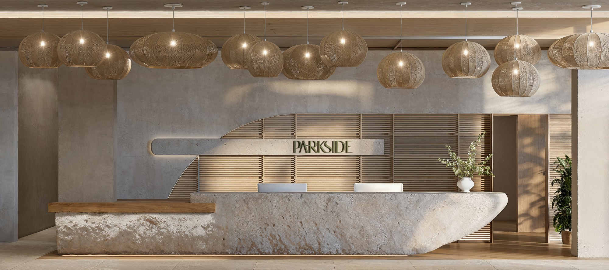 Recepción de Parkside Residences con mostrador de piedra, lámparas de fibra natural y el letrero PARKSIDE